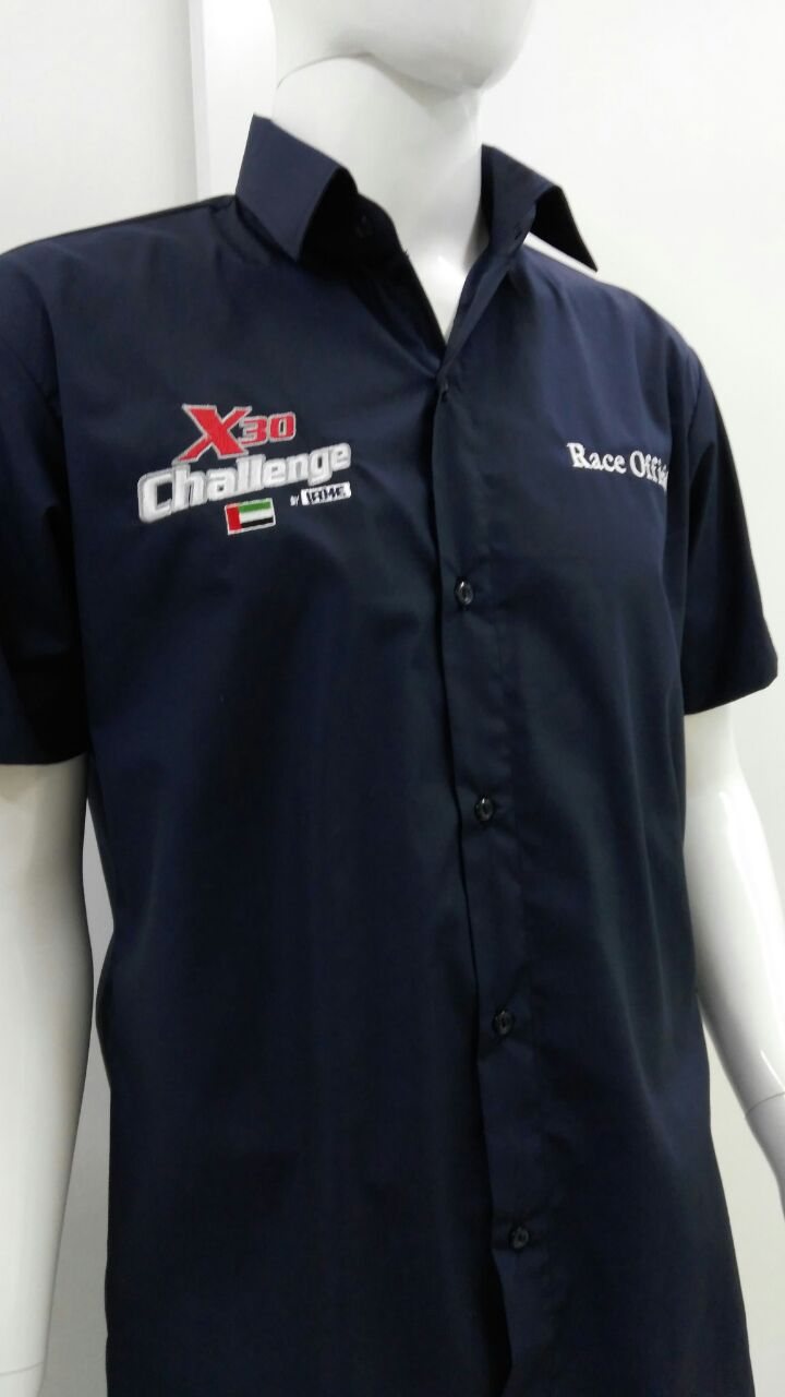 Navy short-sleeve work shirt with embroidered logos on the chest on a mannequin