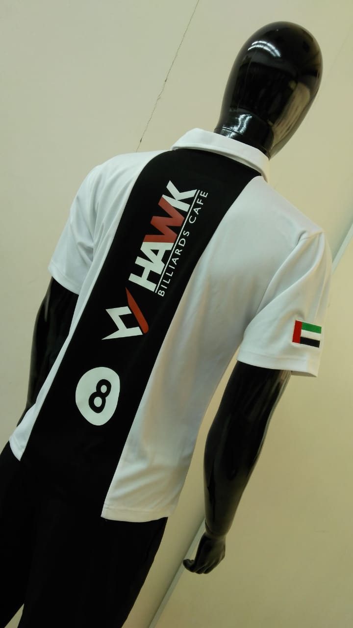 Black-and-white sports jersey with a printed 8-ball graphic and a UAE flag on the sleeve, on a mannequin