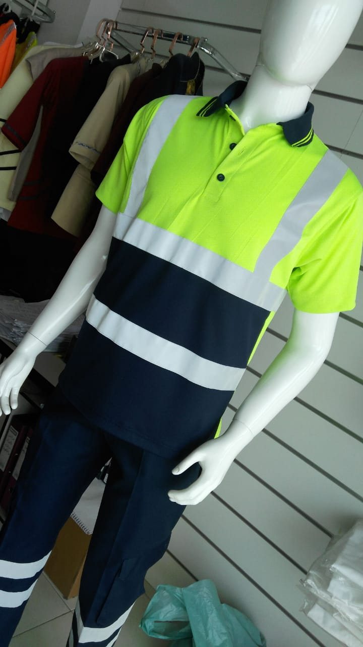 Hi-vis two-tone work shirt in fluorescent yellow and navy with reflective tape, with navy trousers, on a mannequin