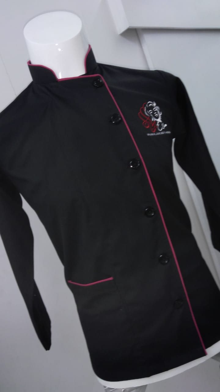 Black chef jacket with red piping and an embroidered chest logo on a mannequin