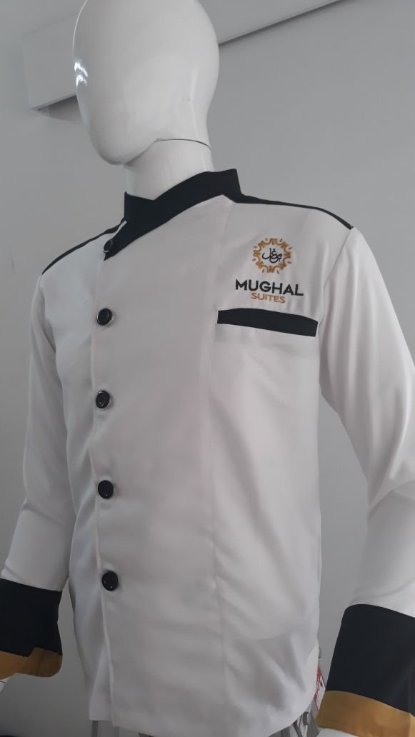 White double-breasted chef jacket with black cuffs, collar trim and an embroidered chest logo on a mannequin